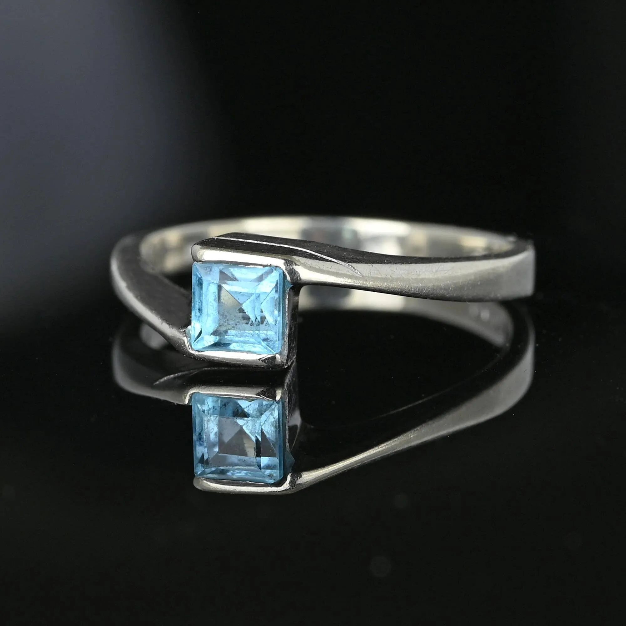 Bypass 10K White Gold Emerald Cut Blue Topaz Ring