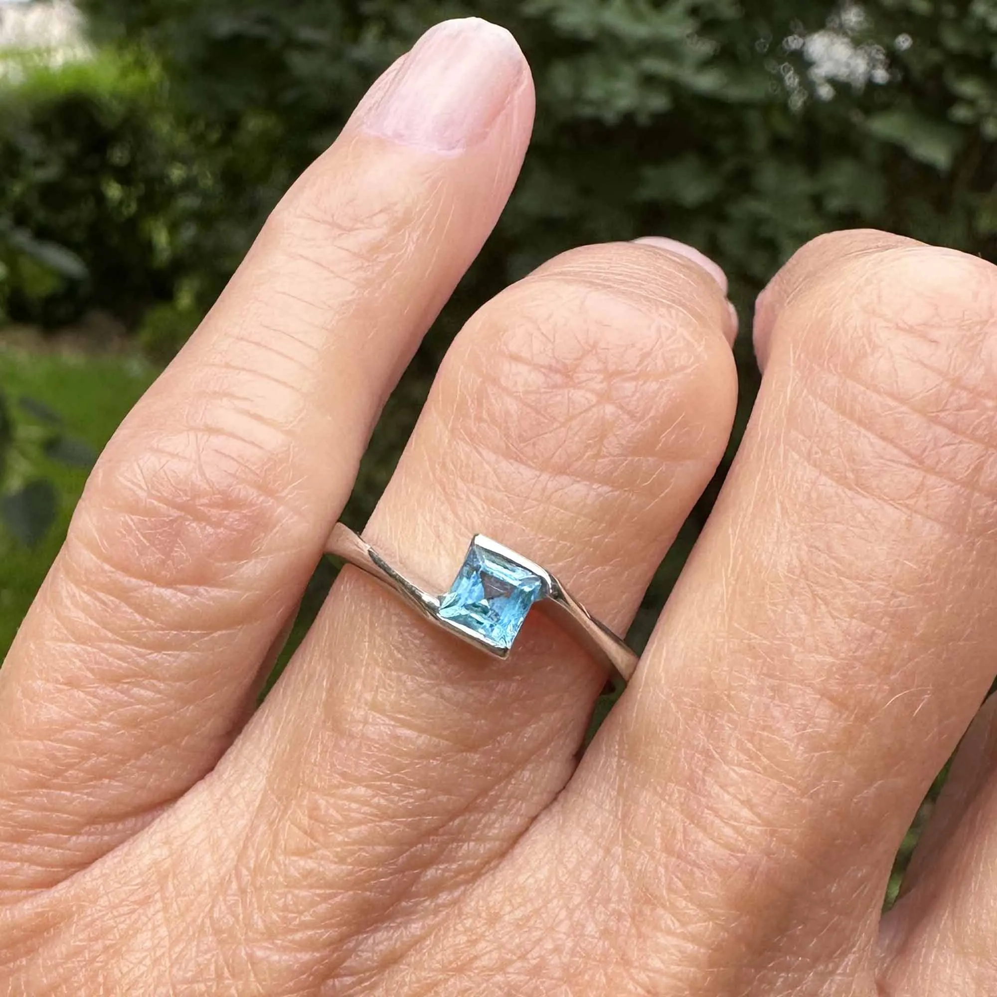 Bypass 10K White Gold Emerald Cut Blue Topaz Ring